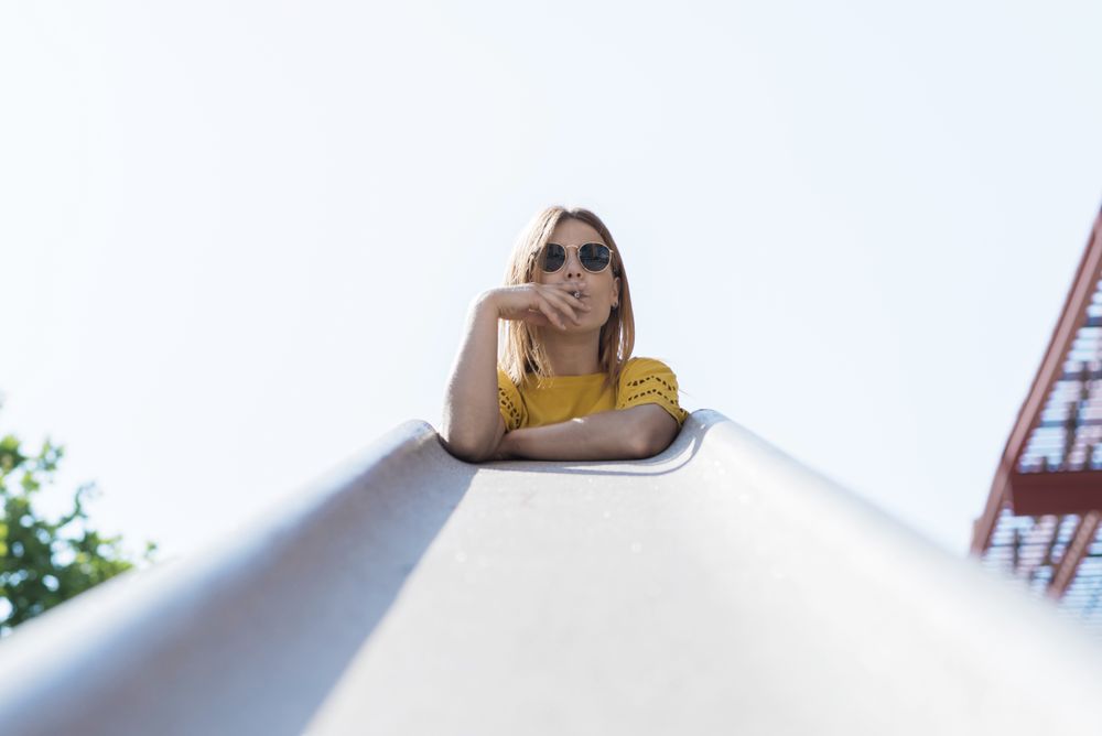 Young woman holding cigarette