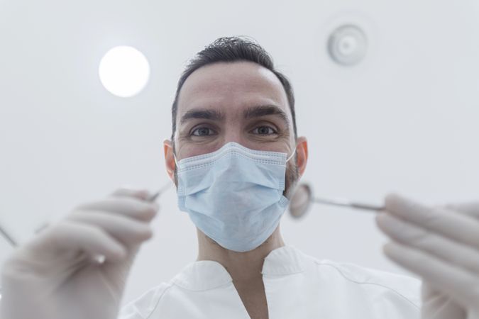 Dentist leaned over chair at clinic