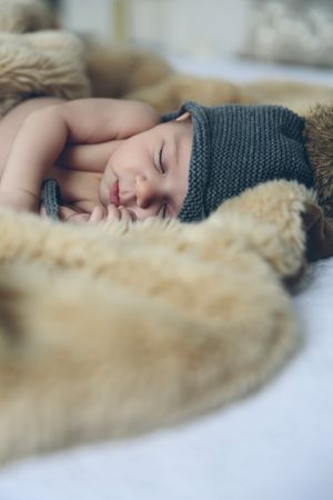 Baby girl with pompom hat sleeping