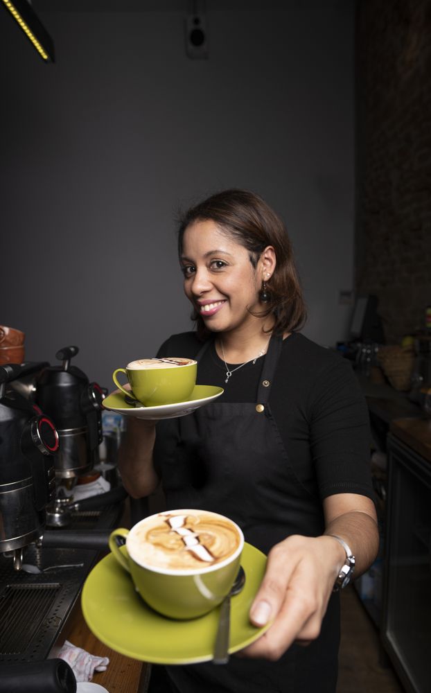 Hispanic woman with cappuccino cups