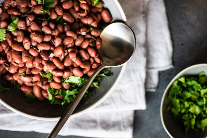 Hearty bowl of Georgian lobio dish atop napkin with cilantro