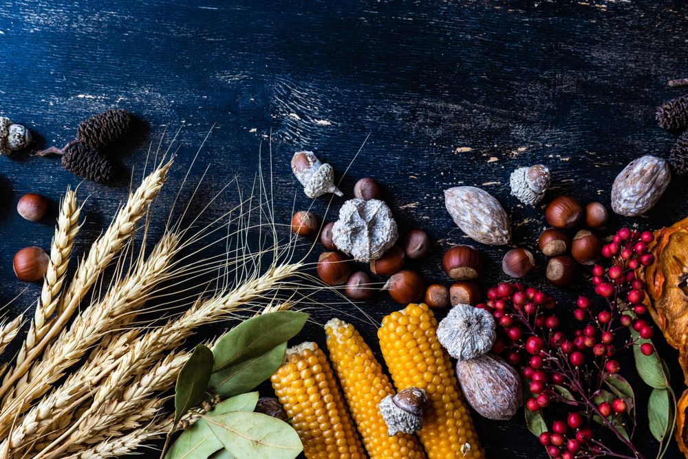 Top view of wooden table with seasonal nuts, berries, vegetable and fruits for autumn season