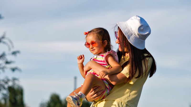 Toddler girl and mom in the sun