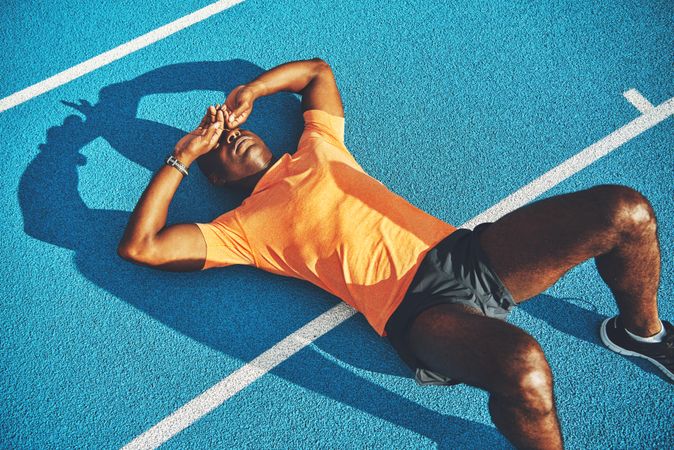 Athlete resting on track after a race