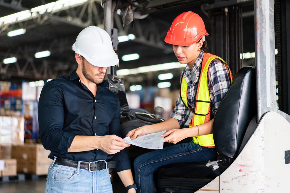 Two colleagues going through material in distribution center