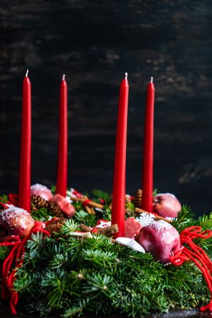 Top view of Christmas wreath with long red candles