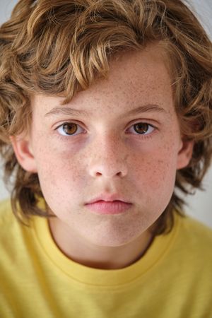 Crop boy with freckles and wavy hair