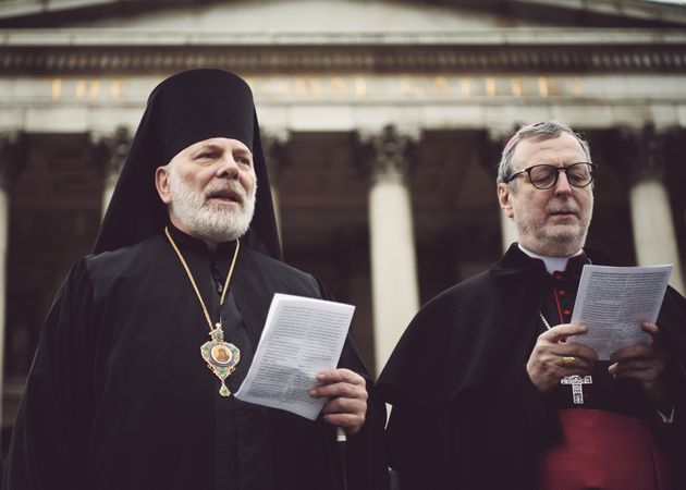 London, England, United Kingdom - March 5 2022: Two religious leaders reading paper outside