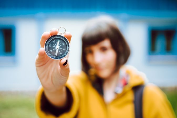 anonymous woman with compass near eye