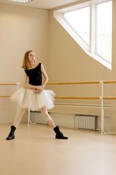 Ballerina practicing in dance studio wearing boots.