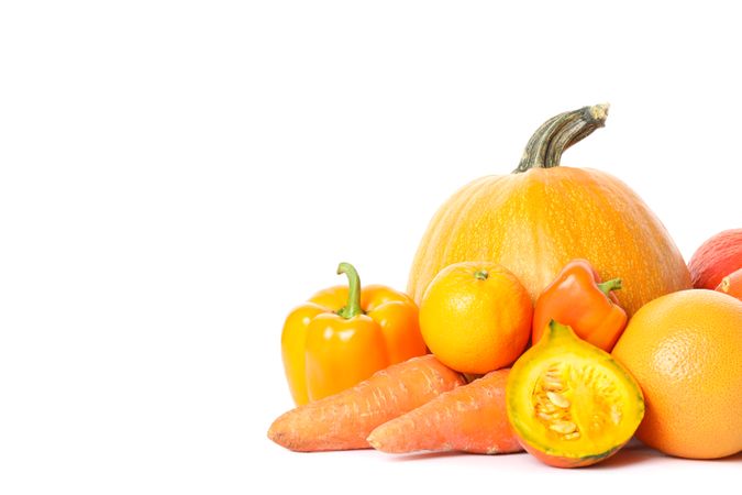 Pumpkins, oranges, carrot and peppers isolated on plain background