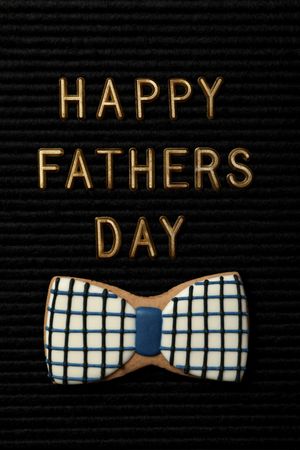 Inscription on a black board for Father's Day, on a dark background.