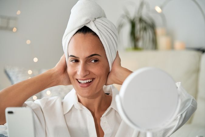 Happy female looking at mirror and shooting video