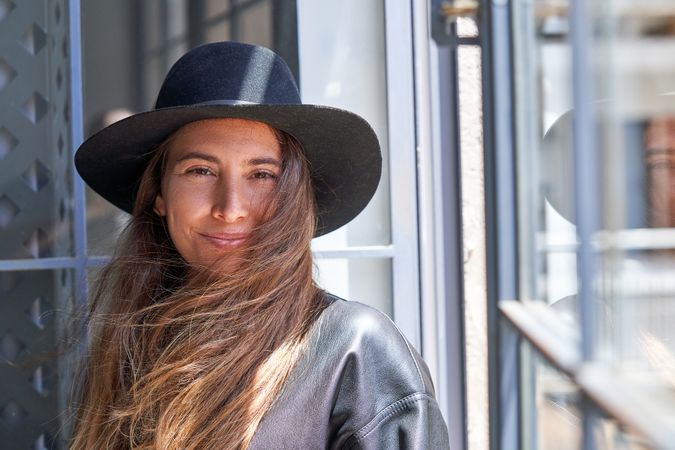 Smiling woman standing near window