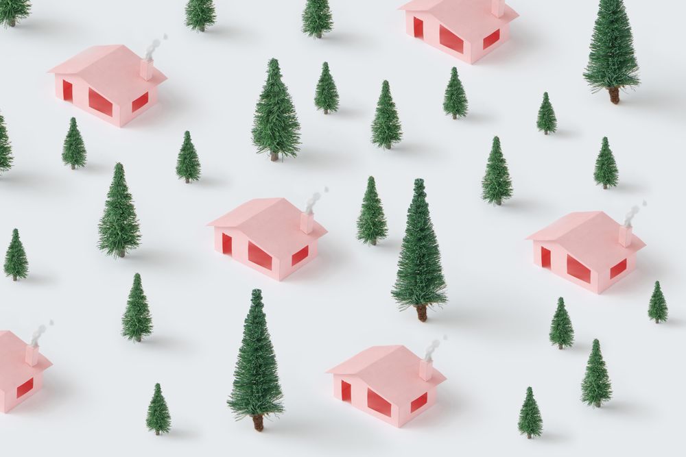 Christmas pattern made with pink houses and pine trees