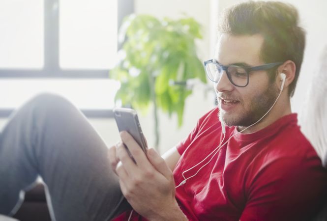 Happy man listening to music on couch