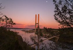 Bridge over river during sunset