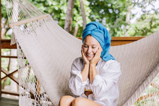 Woman in turban resting in hammock