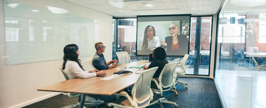 Modern businesspeople having a video conference in a boardroom