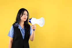 Upset Young Asian Female Holding A Megaphone, Trying to Deliver a Protest Message