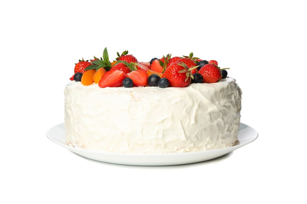 Plate with berry cream cake isolated on plain background