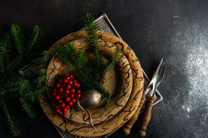 Top view of rustic plates with xmas pine and ornament with copy space