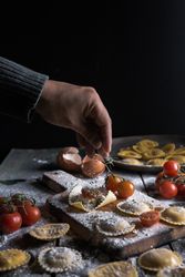Homemade ravioli made with parmesan cheese, tomato and basil.