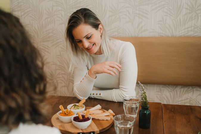 Woman smiling choosing food at table