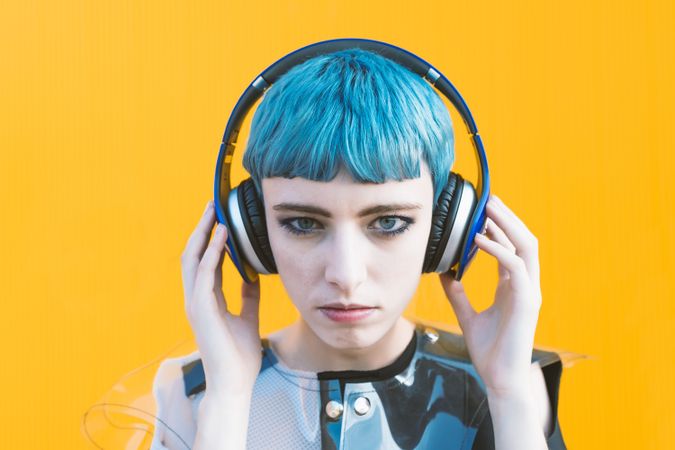 Cool informal woman in headphones on street