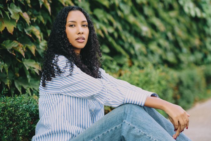 A Casual Portrait of a Young Woman Surrounded by Lush Greenery in the Natural Environment