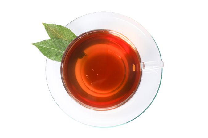 Cup of tea and leaves isolated on blank background