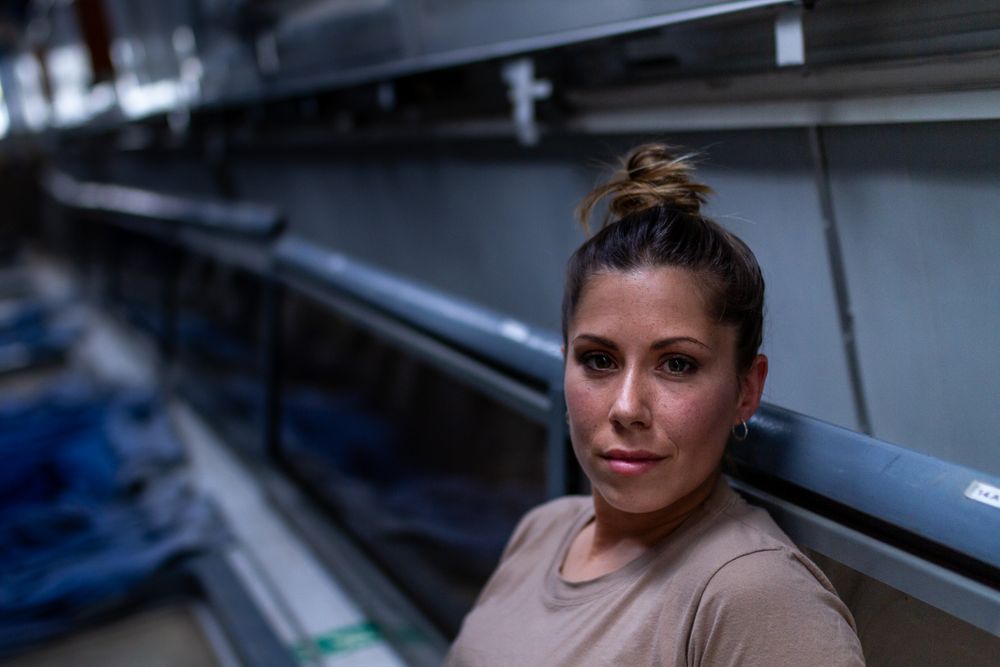 Military woman looking up inside vehicle