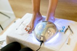 Toe nails under UV light in spa