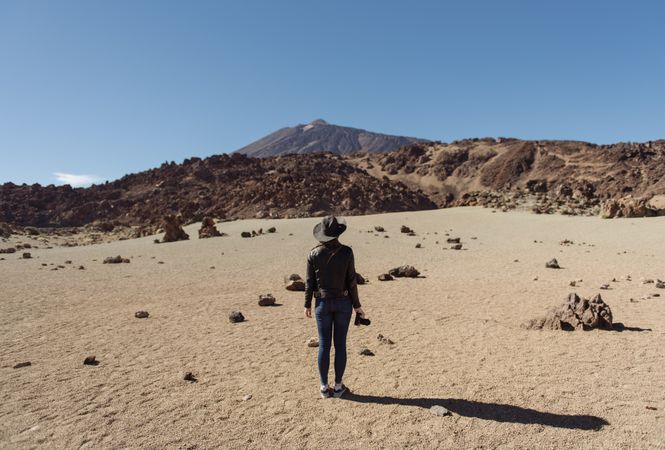 Woman with camera in desert