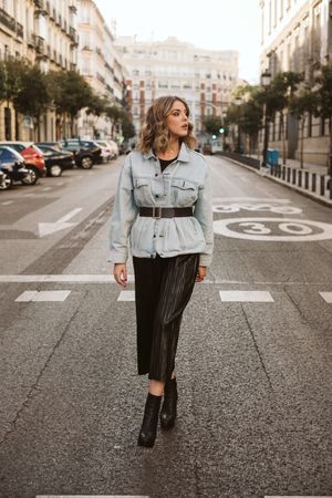 Stylish woman in middle of city road