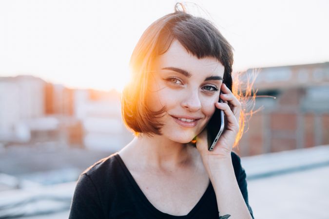 Young woman smiling while taking phone call