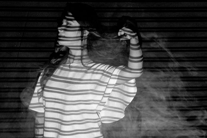 Grayscale photo of woman in light shirt