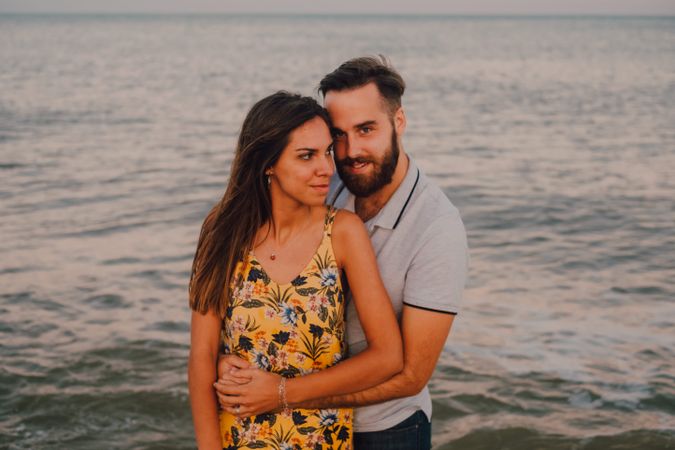 Loving couple embracing happily on sandy beach