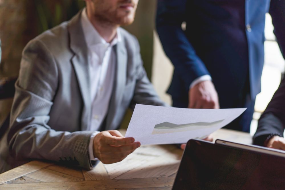 Cropped businessman with a financial document