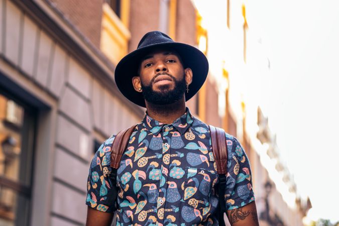 Stylish Black man walking on the city street