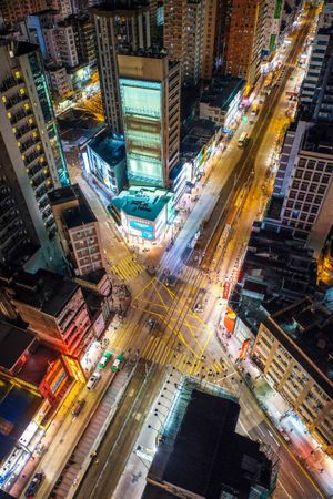 Aerial view of cars on road between city buildings during night time
