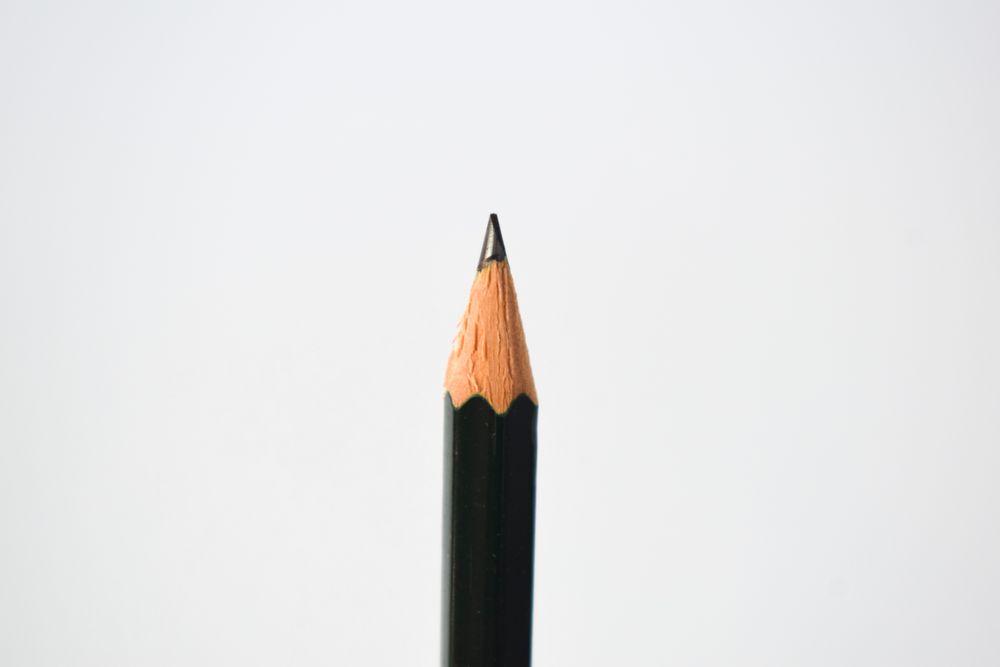 Close up of sharpened pencil straight in center of picture with copy space