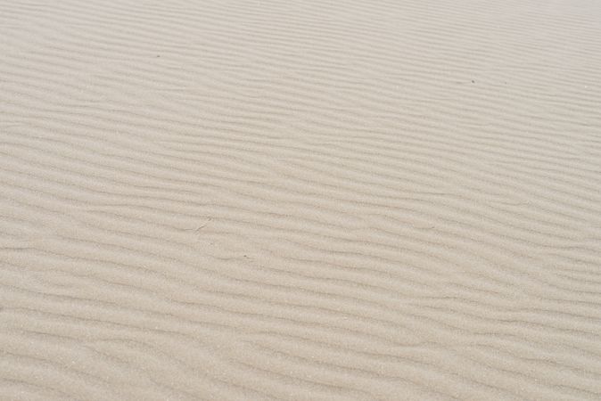 Beachy sand texture background with wave pattern