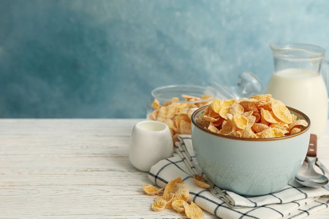 Concept of breakfast with muesli and milk on wooden table