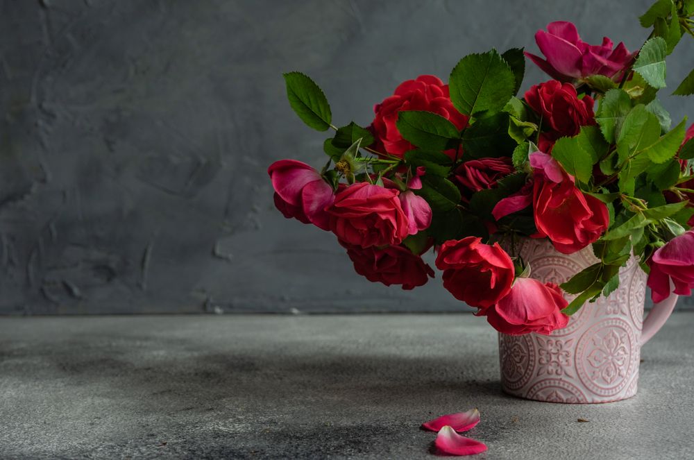 Side view of pink vase holding flowers