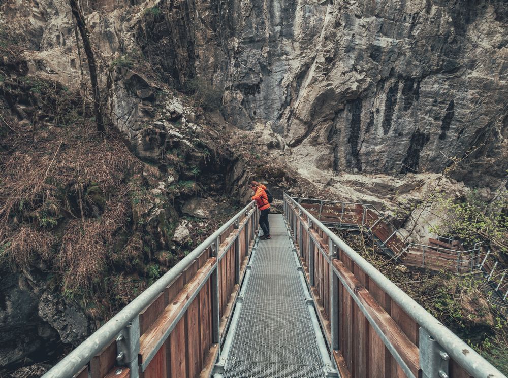 Tourist on hiking path among nature landscape