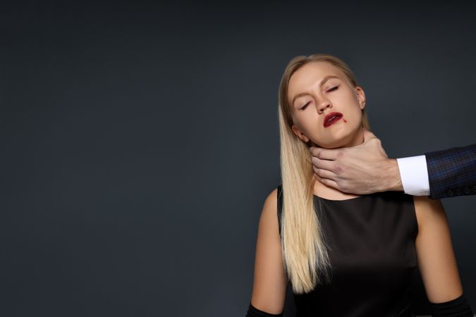 Concept of Halloween, young woman on dark background