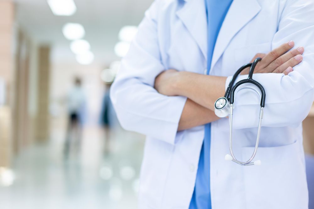 Doctor in hospital with arms crossed and stethoscope