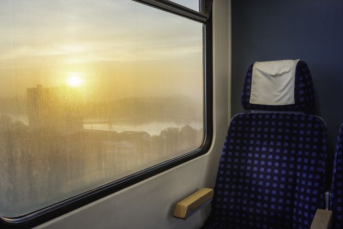 Train interior with sunrise view on window