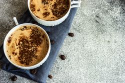 Cups of morning coffee on grey counter
